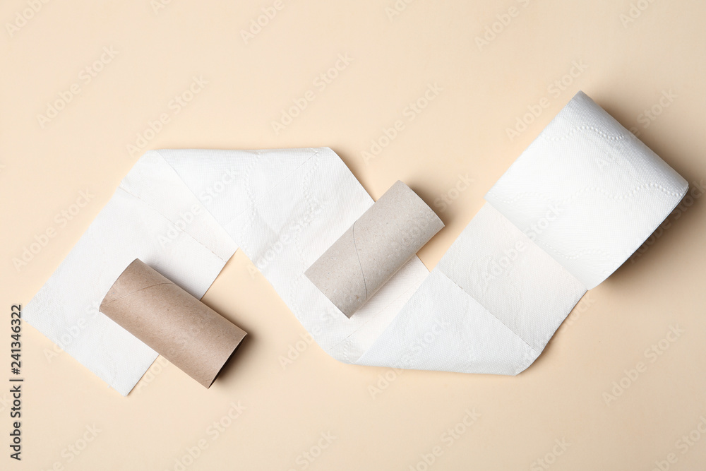 Flat lay composition with toilet paper and empty rolls on color background Flat lay composition with toilet paper and empty rolls on color background