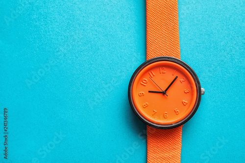 Stylish bright wrist watch on color background, top view with space for text. Fashion accessory