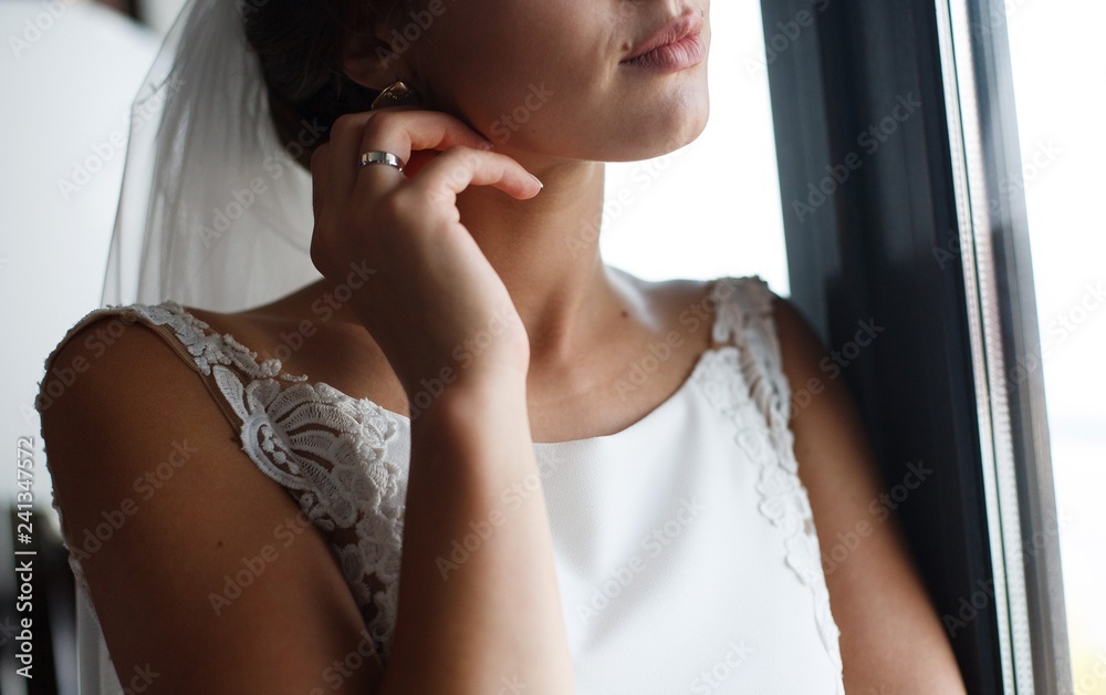beautiful bride corrects earrings
the bride adjusts jewelry
tender morning bride
Portrait of the bride's  face