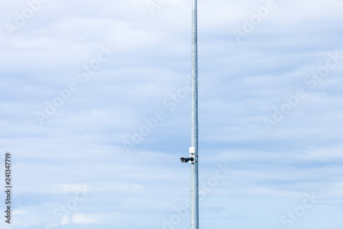 High security surveillance operation covering a work site below on an over cast day. A realistic view of the kinds of conditions security cameras are portrayed and easily noticeable.