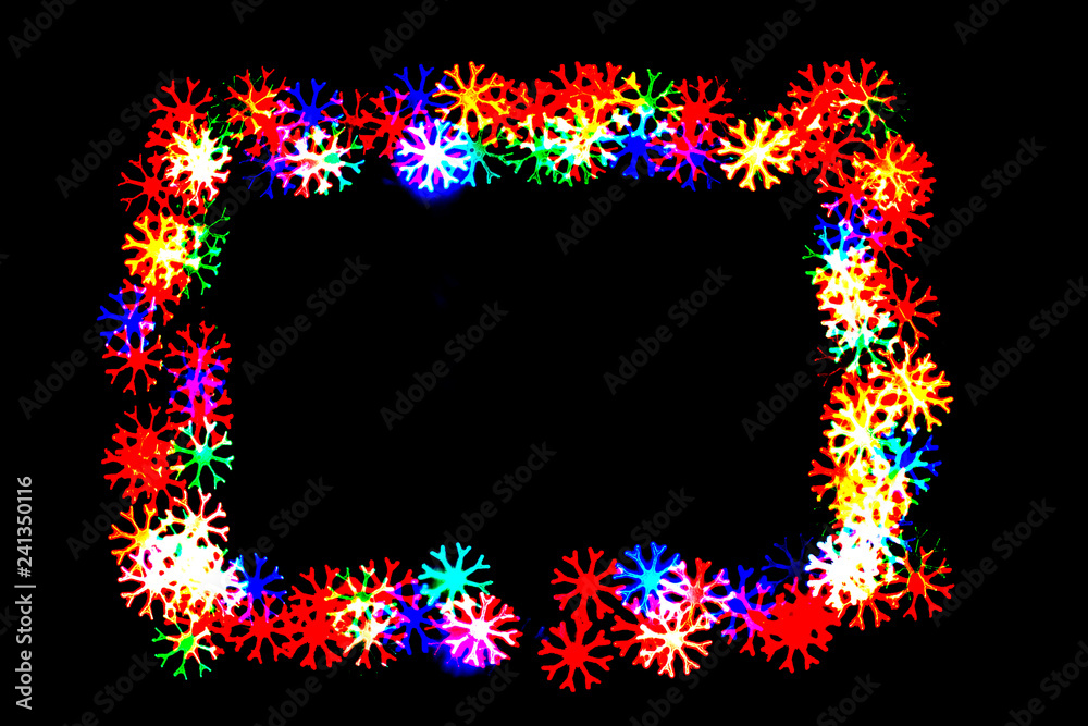 bokeh snowflakes isolated on a black background snowflakes of different colors form a frame.