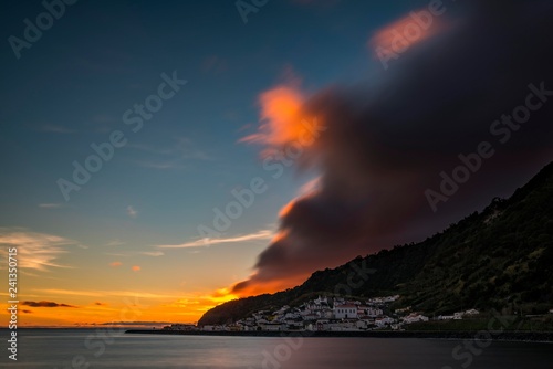 Small village by the sea, sunset with dramatic clouds behind mountain ridges, Ribeira Quente, Sao Miguel, Azores, Portugal, Europe photo