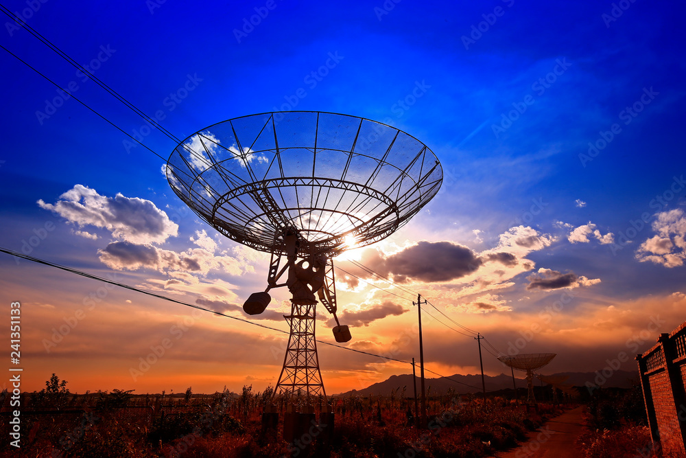 The silhouette of a radio telescope observatory The silhouette of a radio telescope observatory