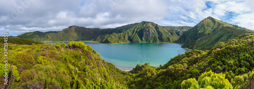 Panoramic landscape with beautiful blue crater lake Lagoa do Fogo from viewpoint Miradouro da Lagoa do Fogo. Lake of Fire is the highest lake of Sao Miguel island, surrounded by Natural Reserve green photo