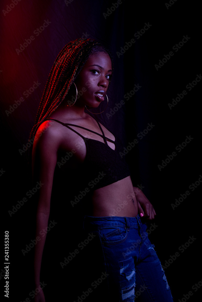 Black woman in studio with colored lights