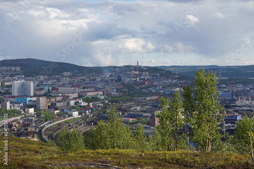 The urban landscape of the Murmansk Soviet architecture and the bright foliage of summer.