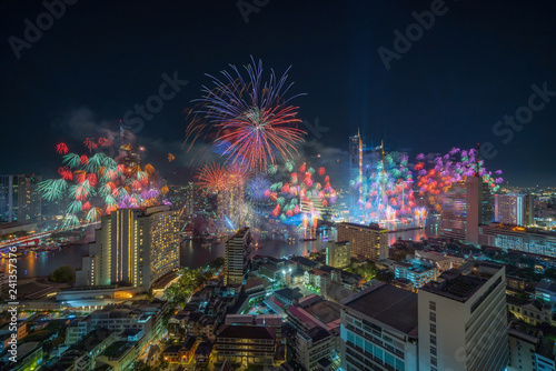 Fantastic Multicolor Firework exploding over the Bangkok Cityscape river side for Celebration, Business architecture and celebration and happy new year and merry christmas concept