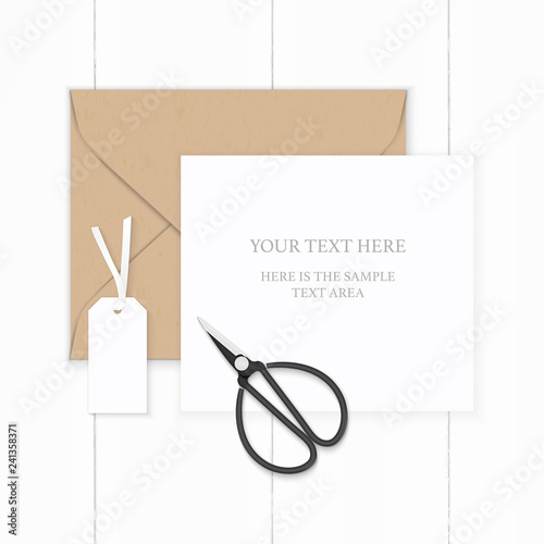 Flat lay top view elegant white composition paper brown kraft envelope tag and metal vintage scissors on wooden background