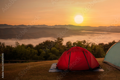 Tent in campsite with sunset or sunrise background