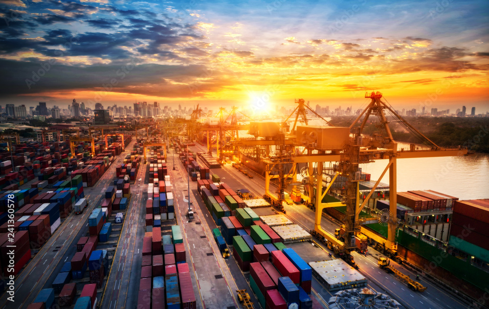 Obraz premium Logistics and transportation of Container Cargo ship and Cargo plane with working crane bridge in shipyard at sunrise, logistic import export and transport industry background