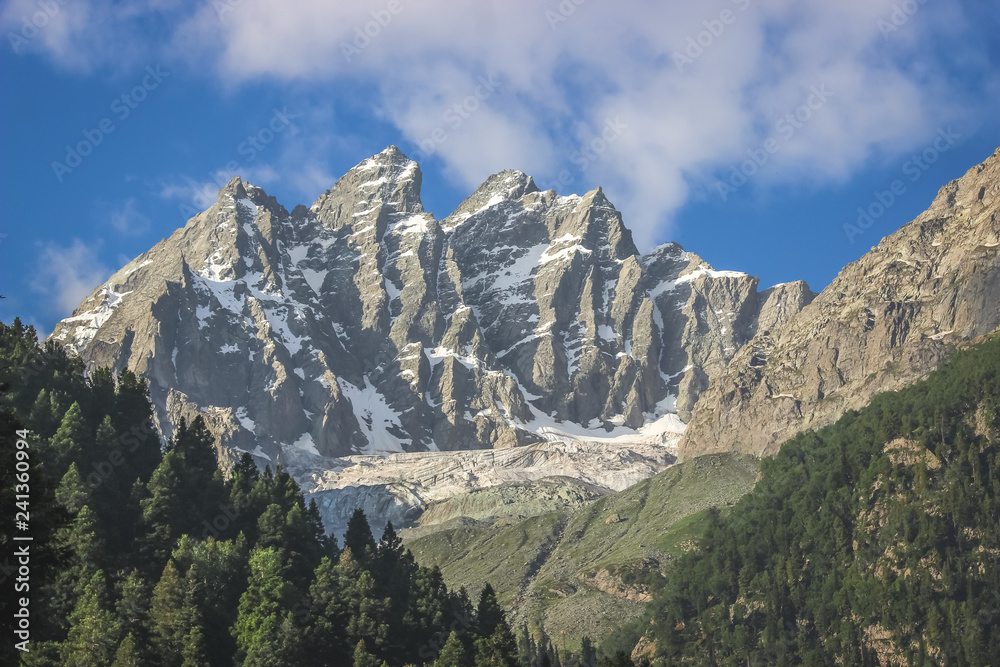 A snow-capped mountain peak. A mountain with a glacier in the Himalayas of Kashmir