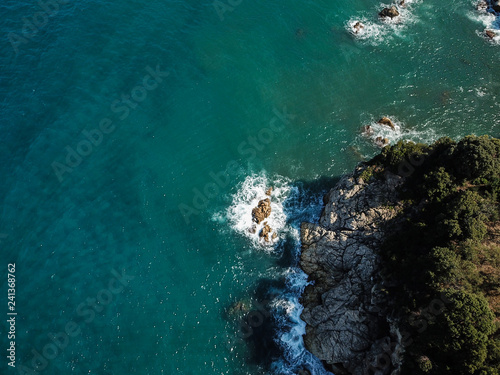 Drone top view of a sea cliff and a beach