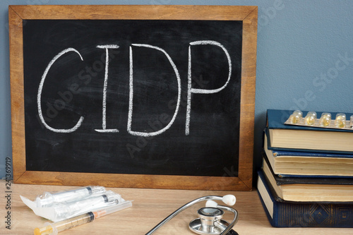 CIDP Chronic Inflammatory Demyelinating Polyneuropathy handwritten on a blackboard. photo