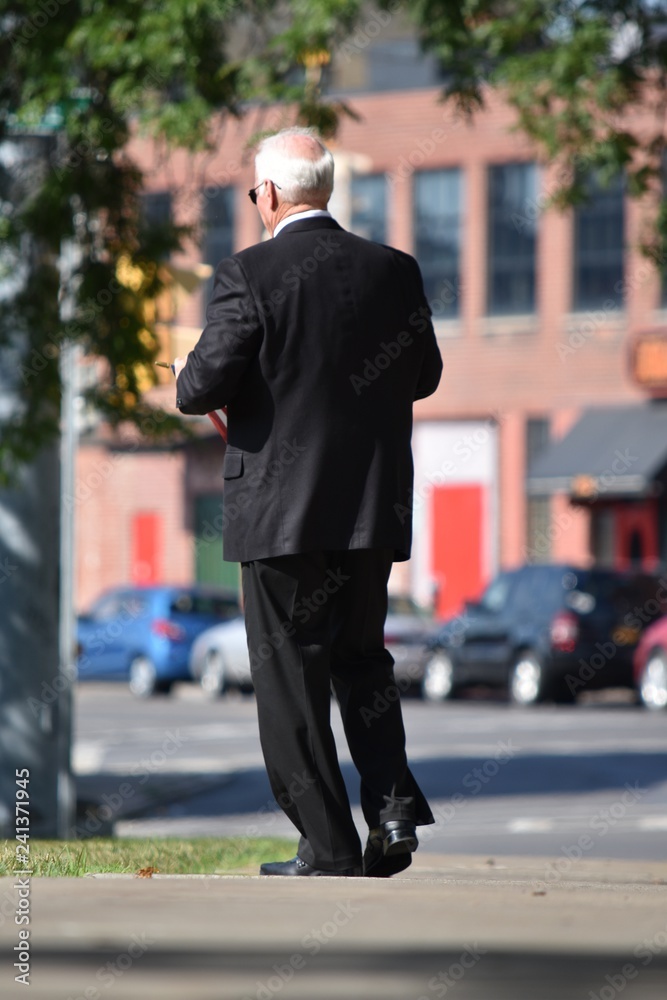 Adult Male Politician And Failure Wearing Suit And Tie Walking On Sidewalk Adult Male Politician And Failure Wearing Suit And Tie Walking On Sidewalk