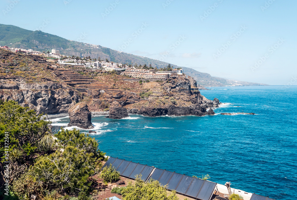 Waves breaking along the rocks in Tenerife, in the Canary Islands on a sunny day.