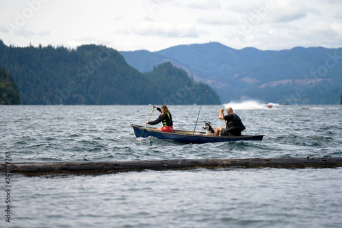 Father with daughter and dog rowing in boat on the troubled lake Merwin photo