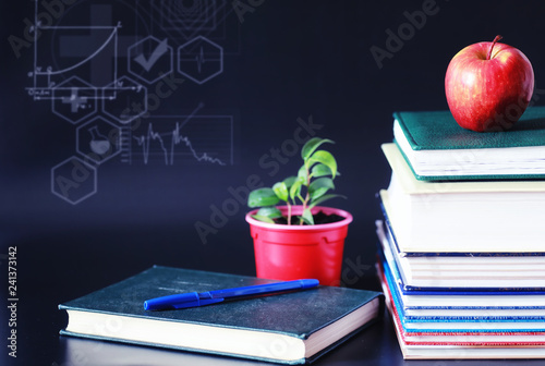 A stack of textbooks and books on the table. The concept of knowledge. photo