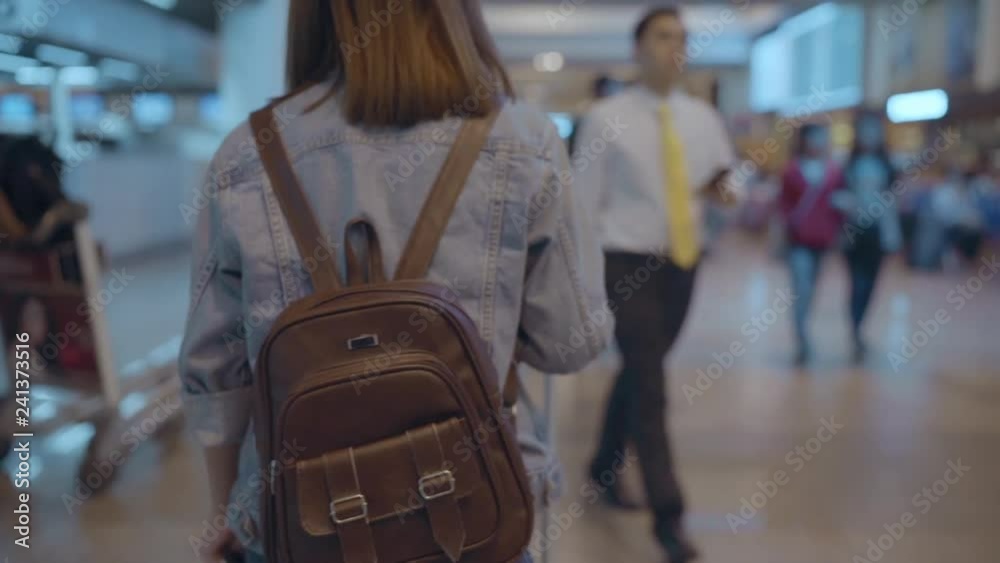 Slow motion - Happy Asian woman using trolley or cart with many luggage walking in terminal hall while going to boarding flight at the departure gate in international airport. Slow motion - Happy Asian woman using trolley or cart with many luggage walking in terminal hall while going to boarding flight at the departure gate in international airport.