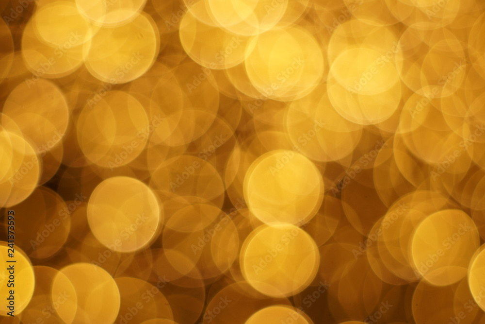 The golden bokeh blurred abstract pattern background. The golden bokeh blurred abstract pattern background.