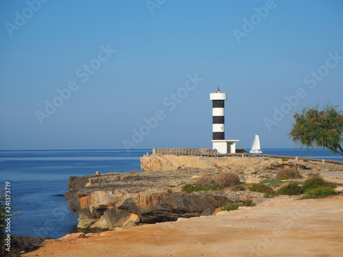 Colonia Sant Jordi, Mallorca, Spain. The lighthouse and the rocks around the village in the morning photo