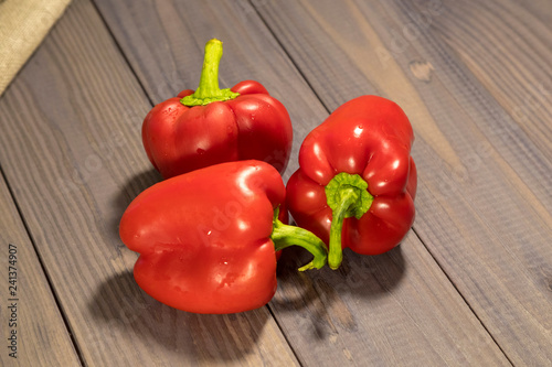Three sweet red peppers on the table