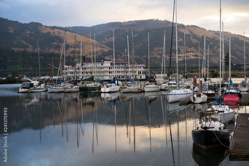 Yachts and boats and travel ship at the pier in the bay on the Columbia River in the Hood River