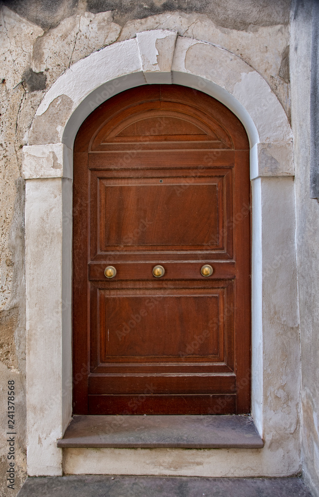 Medieval wooden door, adorned with stone