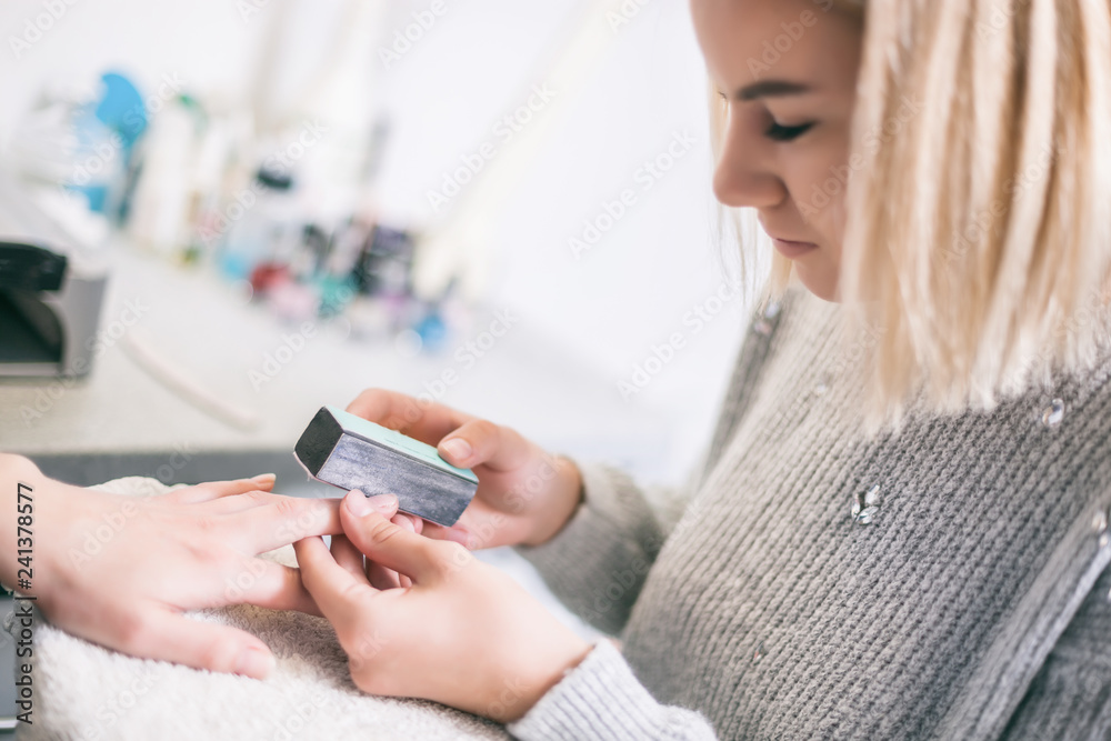 Manicure process at professional saloon. Nail treatment. Manicure process at professional saloon. Nail treatment.