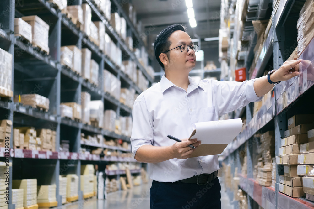 Fototapeta premium Warehouse worker checking goods at warehouse.