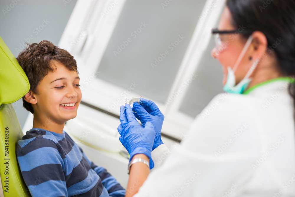 Dentist is teaching little boy about braces. Dentist is teaching little boy about braces.