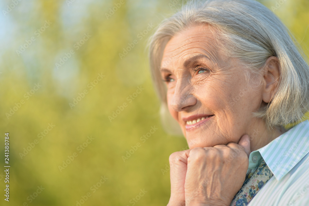 Portrait of happy beautiful elderly woman posing outdoors Portrait of happy beautiful elderly woman posing outdoors
