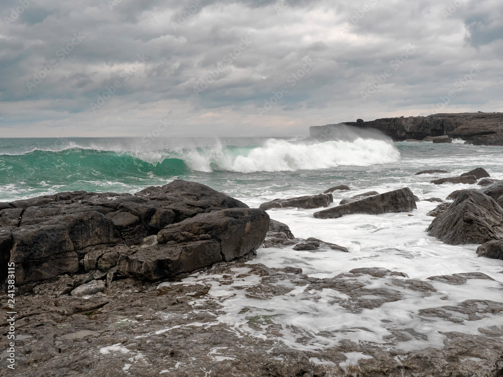 Atlantic ocean, waves crushing on stone coast line. cloudy sky, West coast of Ireland. Atlantic ocean, waves crushing on stone coast line. cloudy sky, West coast of Ireland.