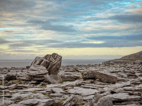 Rough terrain West coast of Ireland Burren region. Stone plateau by Atlantic ocean, Wild Atlantic way. Blue cloudy sky. 