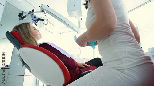 The dentist is preparing to examine the patient. Dental treatment