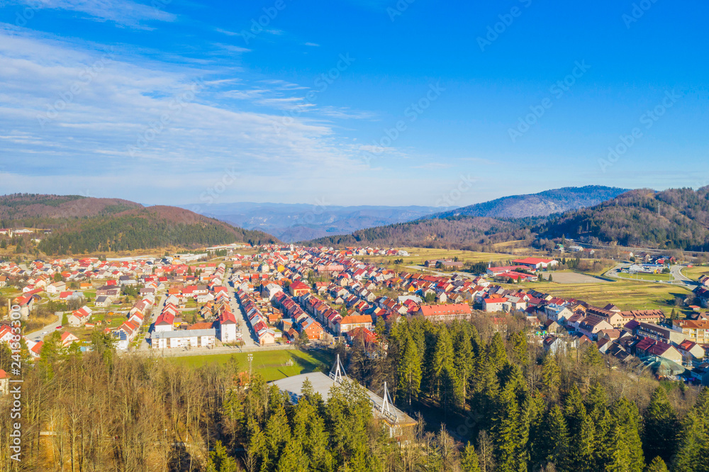 Croatia, Delnice, Gorski kotar, panoramic view of town center from drone in winter, mountain landscape in background