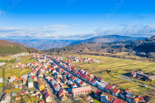 Croatia, Delnice, Gorski kotar, panoramic view of town center from drone in winter, mountain landscape in background photo