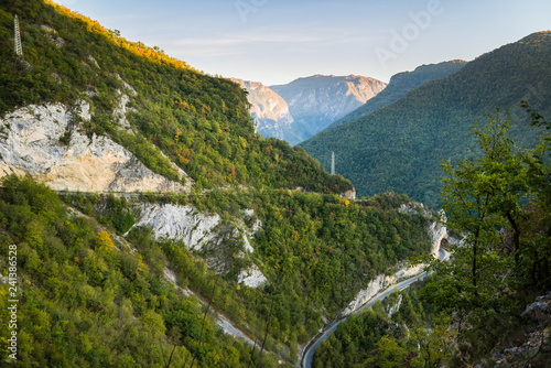 Beautiful green ravine in mountains with Hairpin turn road and tunnel