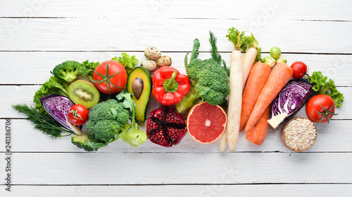 Fototapeta Naklejka Na Ścianę i Meble -  Fresh vegetables and fruits on a white wooden background. Healthy Organic Food. Top view. Free copy space.