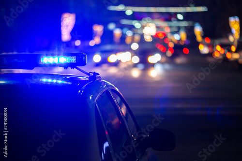 Obraz na płótnie police car lights at night in city with selective focus and bokeh