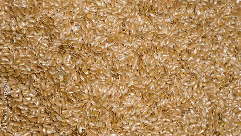 Pile of flax seeds on rotating table, macro view, healthy food Pile of flax seeds on rotating table, macro view, healthy food