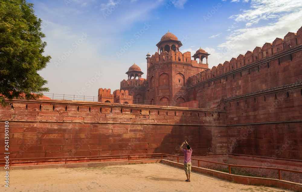 Male tourist take photograph of the historic Red Fort at Delhi India.