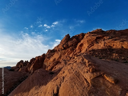 Ethereal rock giant emerges in front of early morning, blue sky