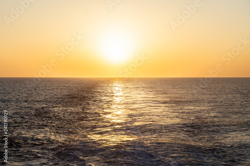 Sunset over the sea. View of the ocean or sea. On the surface of the water there are not big waves. Cloudless weather. Empty background. Free space. 2