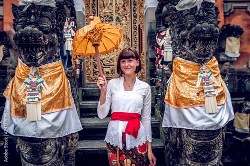 European young woman in balinese traditional temple. Bali island. photo