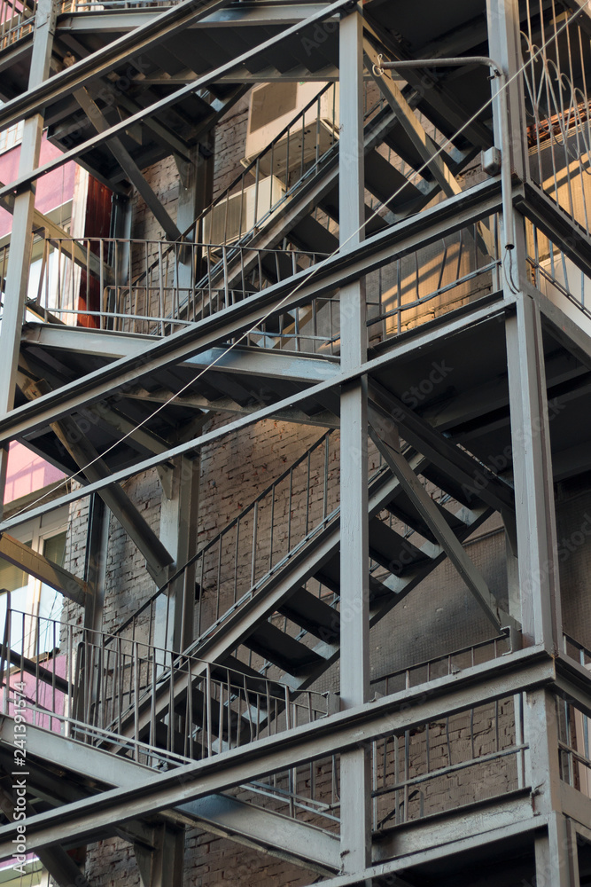 Fototapeta premium Metal construction of fire escape. Close-up. Vertical image