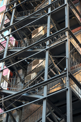 Metal fire escape of high building. Close-up view. Vertical image