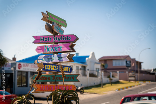 Colorful wooden direction sign in Jeffreys Bay town, South Africa