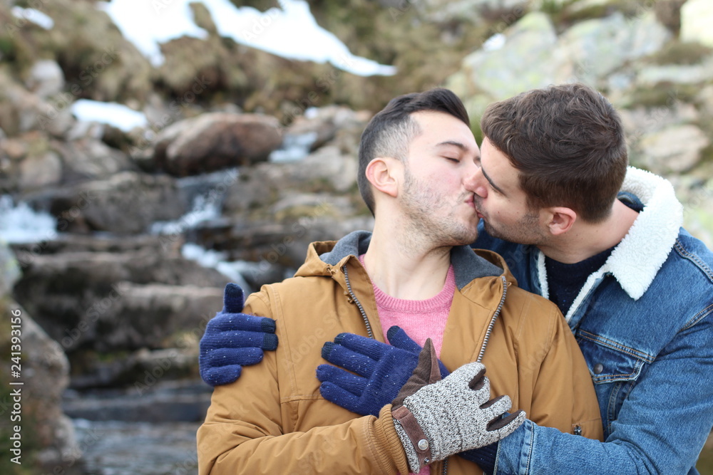 Gay couple kissing in nature Stock Photo | Adobe Stock