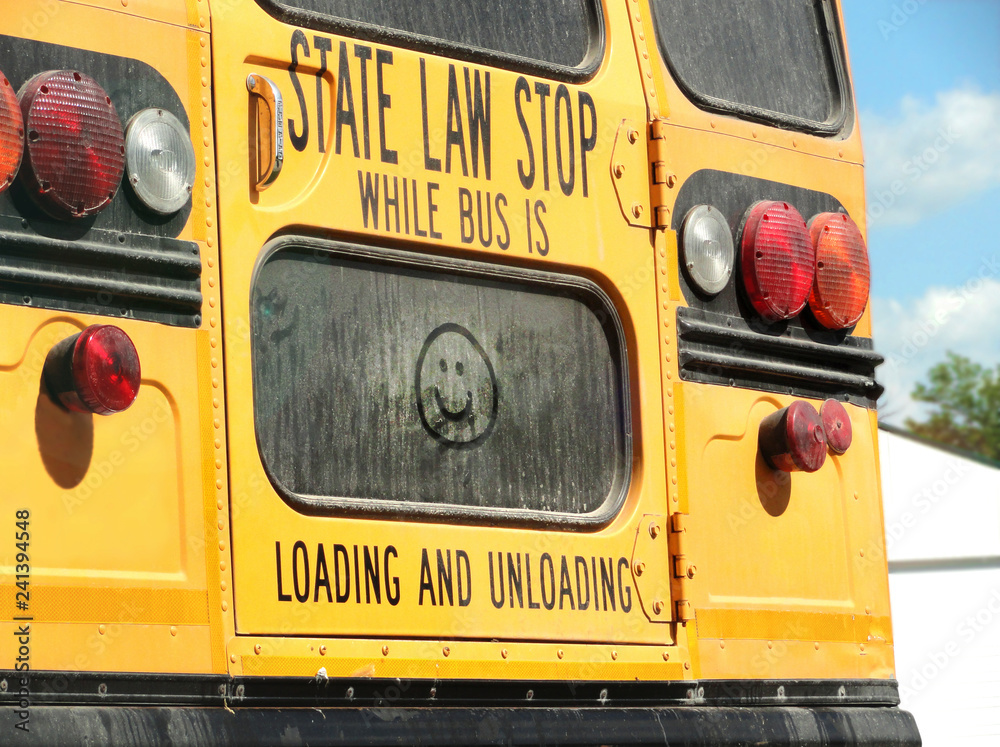 School Bus with Happy Face Drawing on Back Window