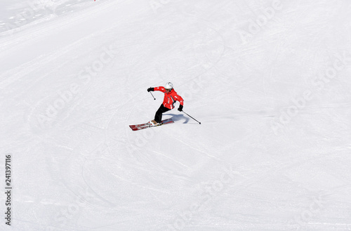 Skier skiing downhill during sunny day in high mountains. Italy, Europe.